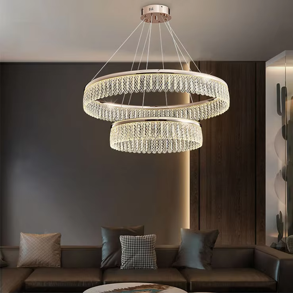 Modern light luxury double-layer ring crystal chandelier, featuring a rose gold metal frame paired with dense crystal strips to create a double-layer suspended shape. Light refracts through the crystals to produce a brilliant and soft glow, combining sophistication and ambiance, making it a high-end decorative lighting fixture that elevates the space's style.