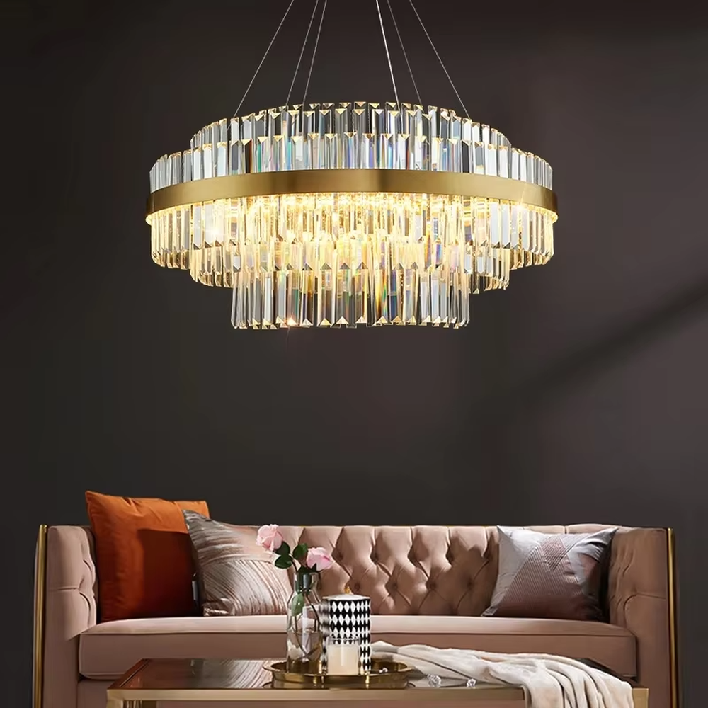 This modern light luxury two-layer circular crystal chandelier features a gold metal frame, with dense transparent long crystals hanging down to form a full circular shape. When lit, light refracts through the crystal to emit a brilliant and soft glow, combining a luxurious texture with an ambient atmosphere. Ideal for dining rooms, living rooms, light luxury apartments, and other spaces, it adds an exquisite and sophisticated touch to modern minimalist or light luxury home environments.
