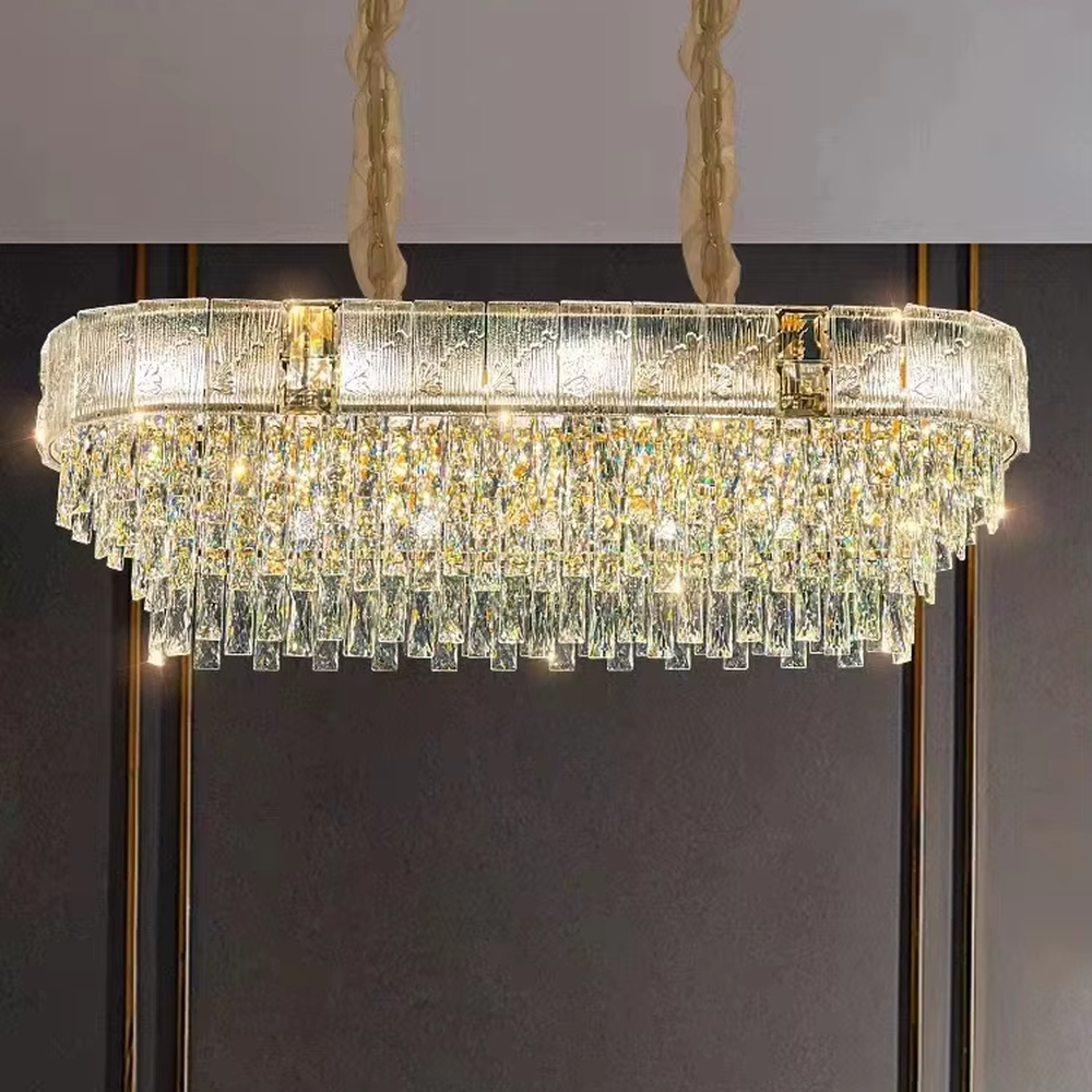 This light luxury and grand multi-layer conical crystal chandelier features a gold metal frame, with vertical-textured glass lampshades on the upper layer and multiple layers of transparent crystal tassels hanging below, creating a full conical shape. When lit, light refracts through the crystal to emit a brilliant and luxurious glow, combining elegant texture with an ambient atmosphere. Ideal for living rooms, dining rooms, villa high-ceiling spaces, and other areas, it adds an elegant and exquisite touch to European light luxury or modern luxury home environments.