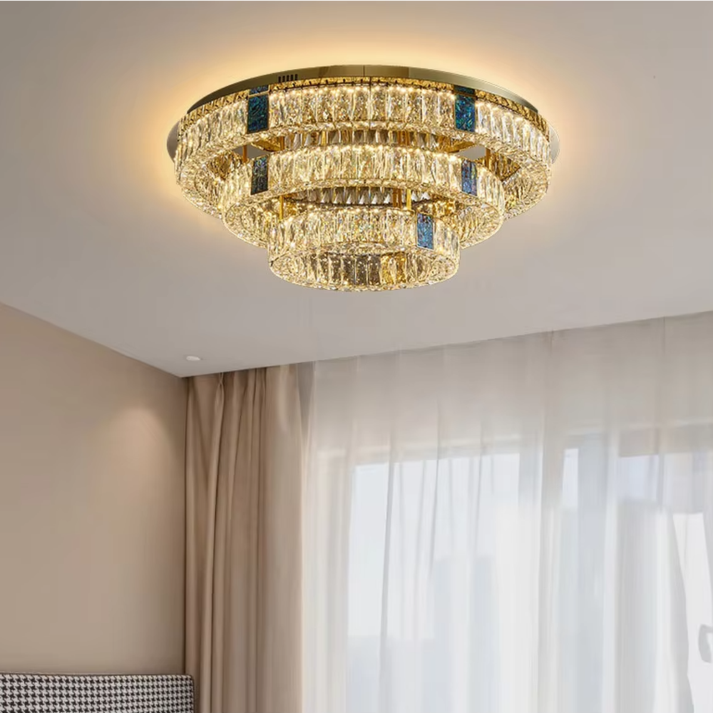 This light luxury and grand multi-layer conical crystal chandelier features a gold metal frame, with vertical-textured glass lampshades on the upper layer and multiple layers of transparent crystal tassels hanging below, creating a full conical shape. When lit, light refracts through the crystal to emit a brilliant and luxurious glow, combining elegant texture with an ambient atmosphere. Ideal for living rooms, dining rooms, villa high-ceiling spaces, and other areas, it adds an elegant and exquisite touch to European light luxury or modern luxury home environments.