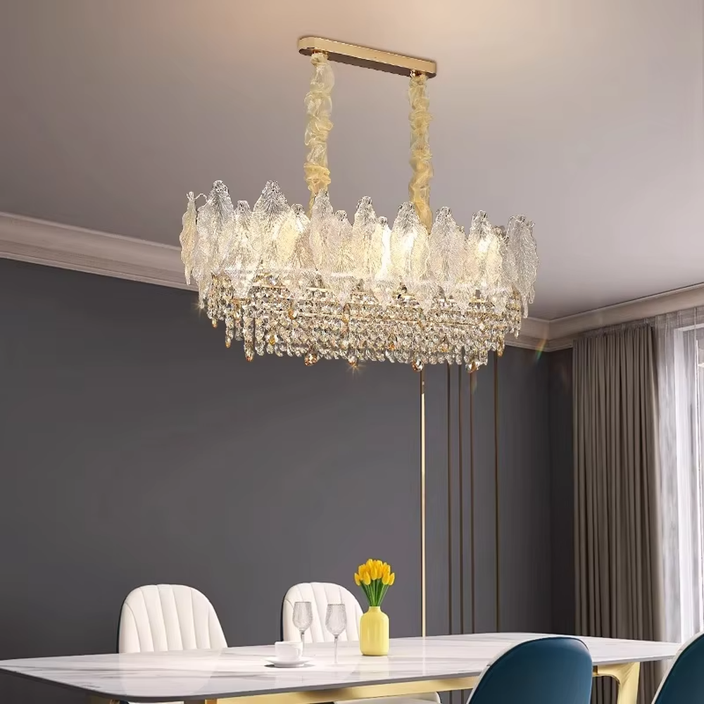 This modern light luxury linear crystal chandelier features a wavy upper lampshade made of transparent textured crystal slices, with dense crystal tassels hanging below, suspended by braided cords. When lit, light refracts through the crystal to emit a brilliant and soft glow, combining an ethereal texture with an ambient atmosphere. Ideal for dining rooms, bars, light luxury apartments, and other spaces, it adds a dreamy and exquisite touch to modern minimalist or French light luxury home environments.