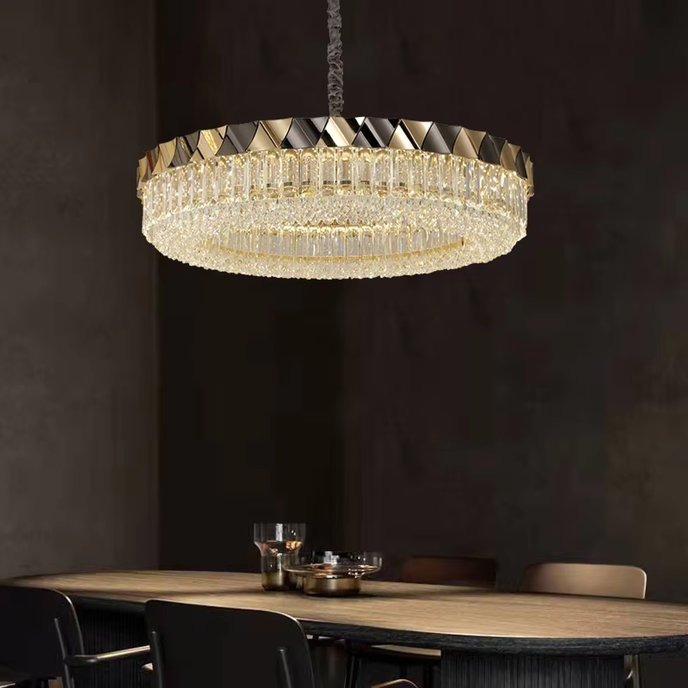 This modern light luxury two-layer circular crystal chandelier features a black-and-gold metal frame, inlaid with transparent long crystals to form a double-layered dome shape. The geometric black-and-gold metal contrasts brilliantly with the shimmering crystal, and when lit, light refracts through the crystal to emit a luxurious and soft glow, combining a sophisticated texture with an ambient atmosphere. Ideal for living rooms, dining rooms, light luxury apartments, and other spaces, it adds an exquisite and luxurious touch to modern minimalist or light luxury home environments.