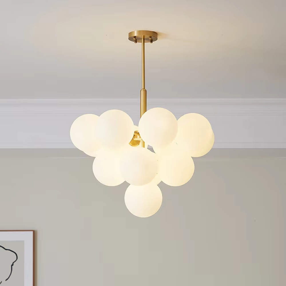 Modern light luxury gold magic bean chandelier, featuring a brass metal frame paired with clustered milk-white frosted glass balls. It emits soft and gentle light, combining warmth and style, making it a decorative lighting fixture that enhances the space's texture.