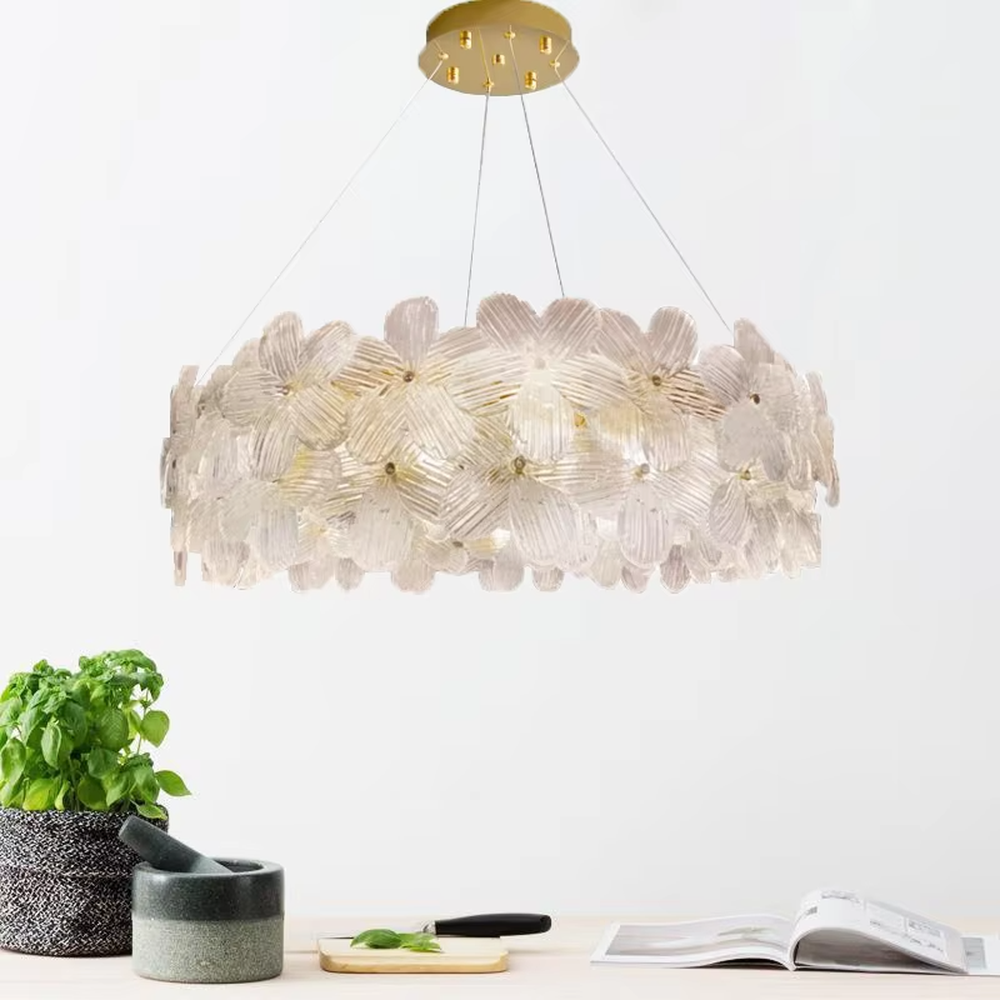 This modern light luxury two-layer petal chandelier is suspended by white cords, composed of two layers of transparent glass petals arranged in a staggered layout with delicate textures. When lit, it emits a soft and gentle glow, combining a romantic ambiance with an ethereal feel. Ideal for living rooms, bedrooms, dining rooms, and other spaces, it adds a dreamy and exquisite touch to modern minimalist or French light luxury home environments.