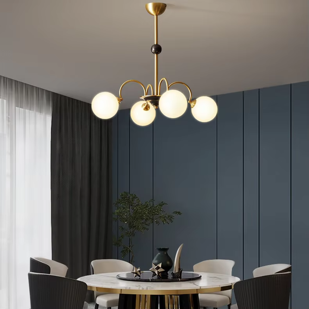 Modern light luxury black and gold magic bean chandelier, featuring curved brackets in black and gold metal paired with milk-white frosted glass ball lampshades. Its rounded, soft, and layered design combines warmth and style, making it a decorative lighting fixture that enhances the space's texture.