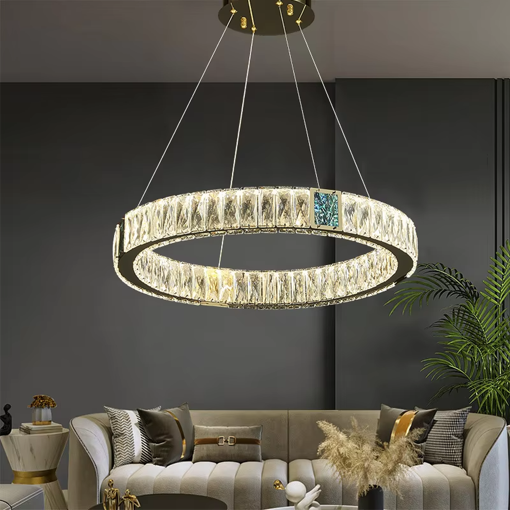 This light luxury and grand multi-layer conical crystal chandelier features a gold metal frame, with vertical-textured glass lampshades on the upper layer and multiple layers of transparent crystal tassels hanging below, creating a full conical shape. When lit, light refracts through the crystal to emit a brilliant and luxurious glow, combining elegant texture with an ambient atmosphere. Ideal for living rooms, dining rooms, villa high-ceiling spaces, and other areas, it adds an elegant and exquisite touch to European light luxury or modern luxury home environments.