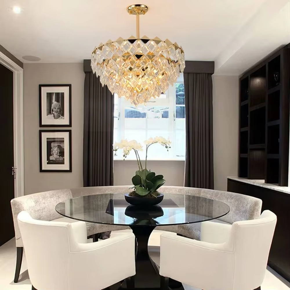 This luxurious and grand diamond-cut crystal chandelier features a gold metal frame, paired with transparent faceted crystals and gold decorative pieces, creating a full spherical shape. When lit, light refracts through the crystal to emit a brilliant and luxurious glow, combining decorative appeal with an ambient atmosphere. Ideal for dining rooms, living rooms, villa high-ceiling spaces, or high-end clubs, it adds an elegant and exquisite touch to European luxury or modern light luxury spaces.
