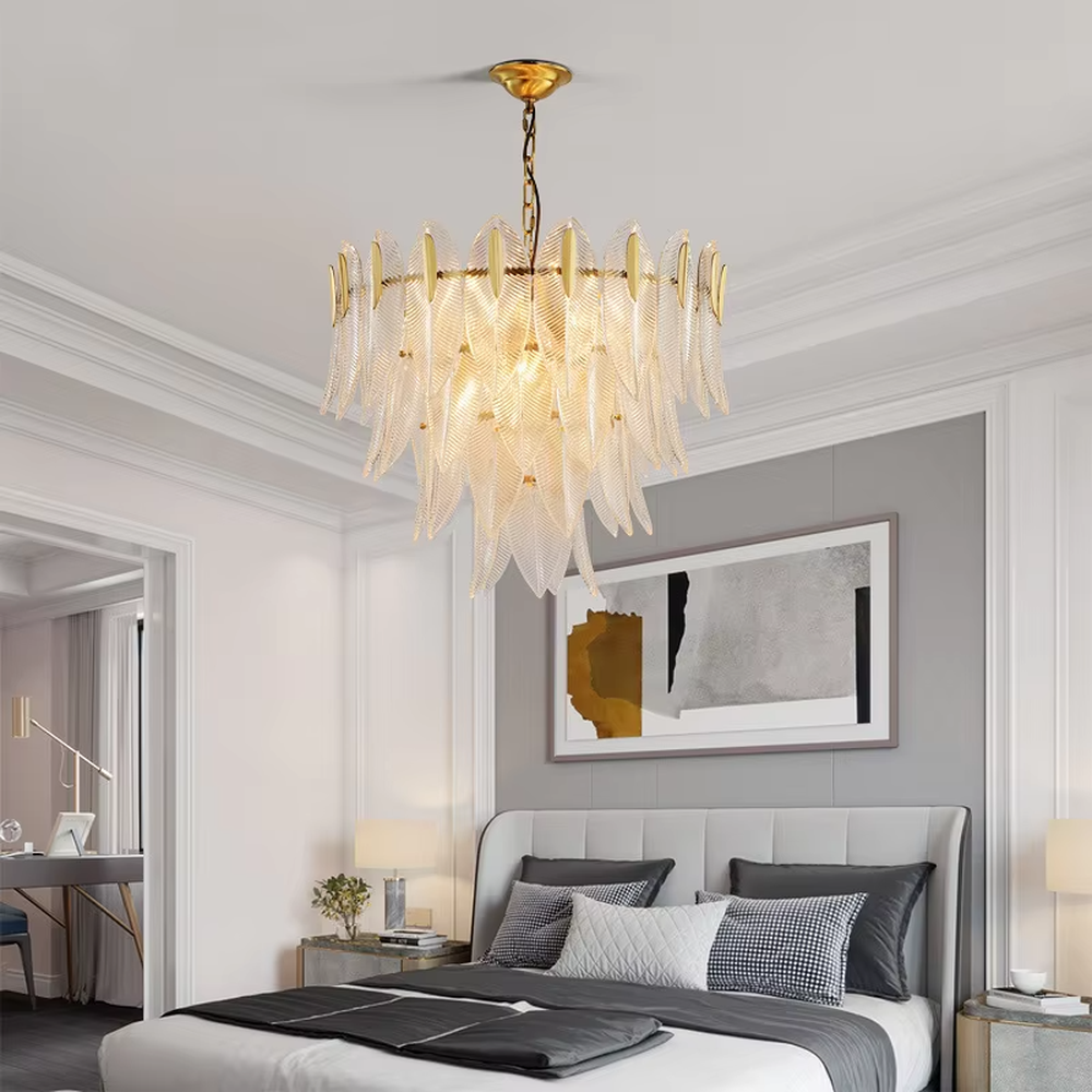 This modern light luxury feather glass chandelier features a gold metal frame, with layered textured feather-shaped glass slices forming a fan shape. When lit, light refracts through the glass to emit a soft and brilliant glow, combining an ethereal texture with an ambient atmosphere. Ideal for living rooms, dining rooms, light luxury apartments, and other spaces, it adds a dreamy and exquisite touch to modern minimalist or French light luxury home environments.
