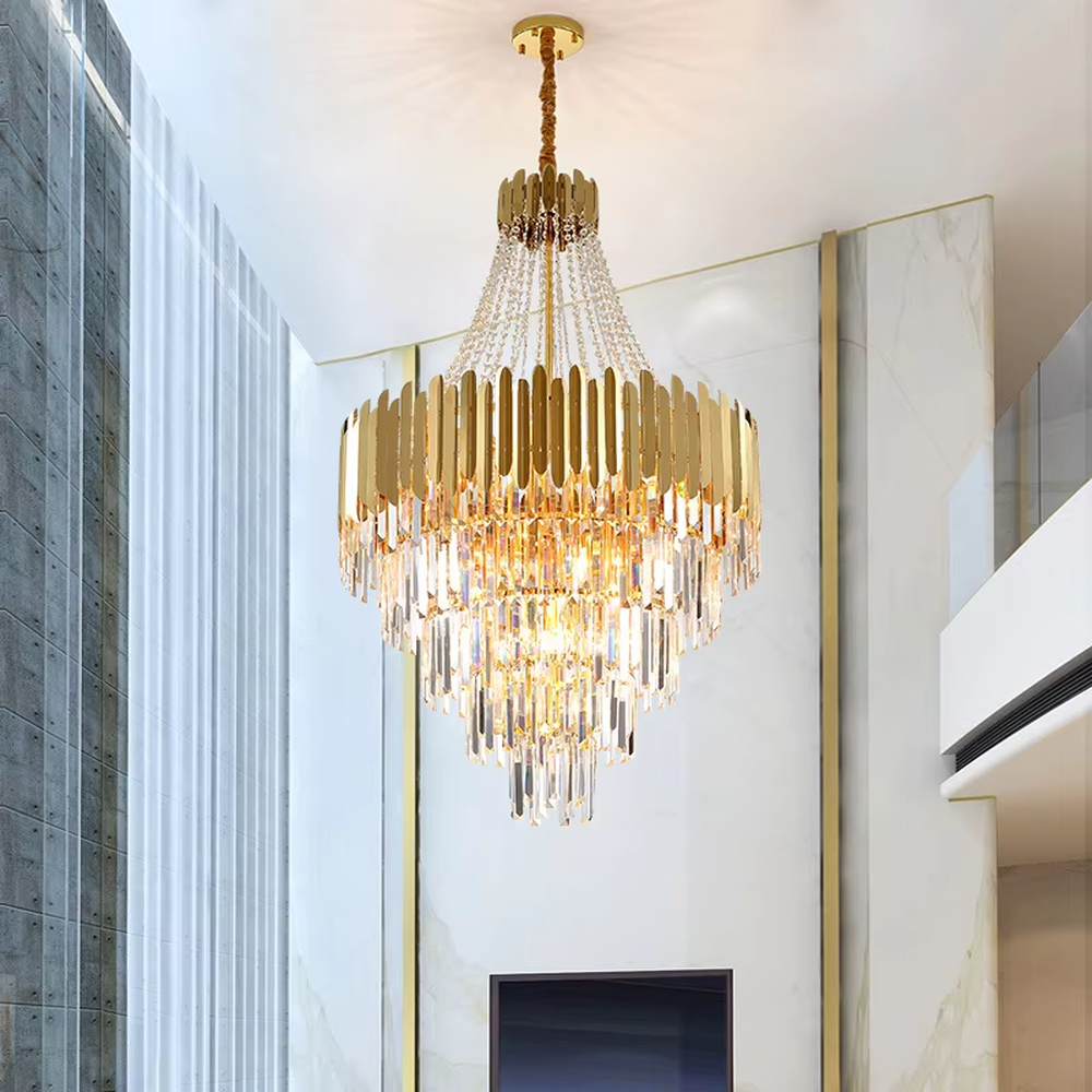 This light luxury and grand multi-layer crystal chandelier features a gold metal frame, paired with transparent crystal pendants and metal decorative pieces, creating a layered conical shape. When lit, light refracts through the crystal to emit a brilliant and luxurious glow, combining decorative appeal with an ambient atmosphere. Ideal for villa living rooms, high-ceiling spaces, hotel lobbies, or duplex foyers, it adds an elegant and exquisite touch to modern light luxury or European-style luxury spaces.