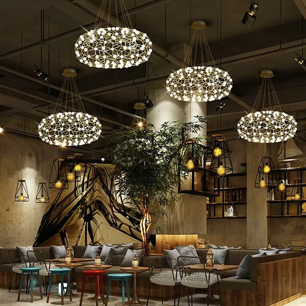 Modern light luxury honeycomb-structure oval chandelier, featuring a bionic honeycomb frame made of gold metal and covered with glowing light beads. It emits soft and brilliant light, combining a sense of technology and artistic ambiance, making it a high-end decorative lighting fixture that elevates the space's style.