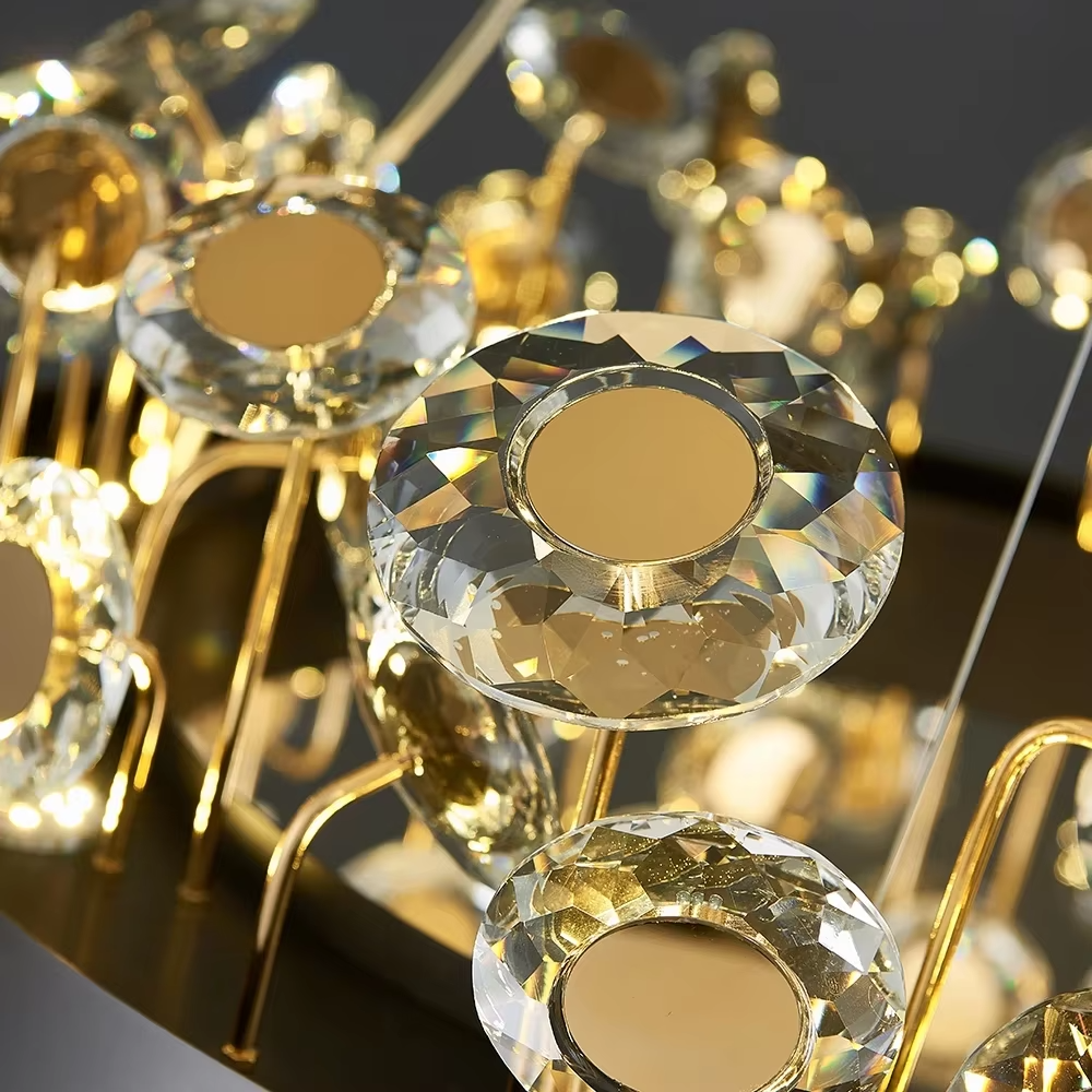 This modern light luxury rectangular crystal chandelier features a gold metal frame inlaid with multiple layers of circular-cut crystals and gold reflective discs. The staggered crystals create a brilliant and luxurious light effect when illuminated, combining decorative appeal with an ambient atmosphere. Ideal for dining rooms, bars, and above dining tables in light luxury apartments, it adds an elegant and exquisite touch to modern light luxury or European-style luxury spaces.
