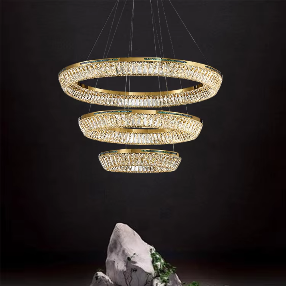 This modern light luxury rectangular two-layer crystal chandelier features a gold metal frame, inlaid with transparent long crystals to form a double-layered rectangular shape. When lit, light refracts through the crystal to emit a brilliant and soft glow, combining an exquisite texture with an ambient atmosphere. Ideal for dining rooms, bars, and above dining tables in light luxury apartments, it adds an exquisite and sophisticated touch to modern minimalist or light luxury spaces.