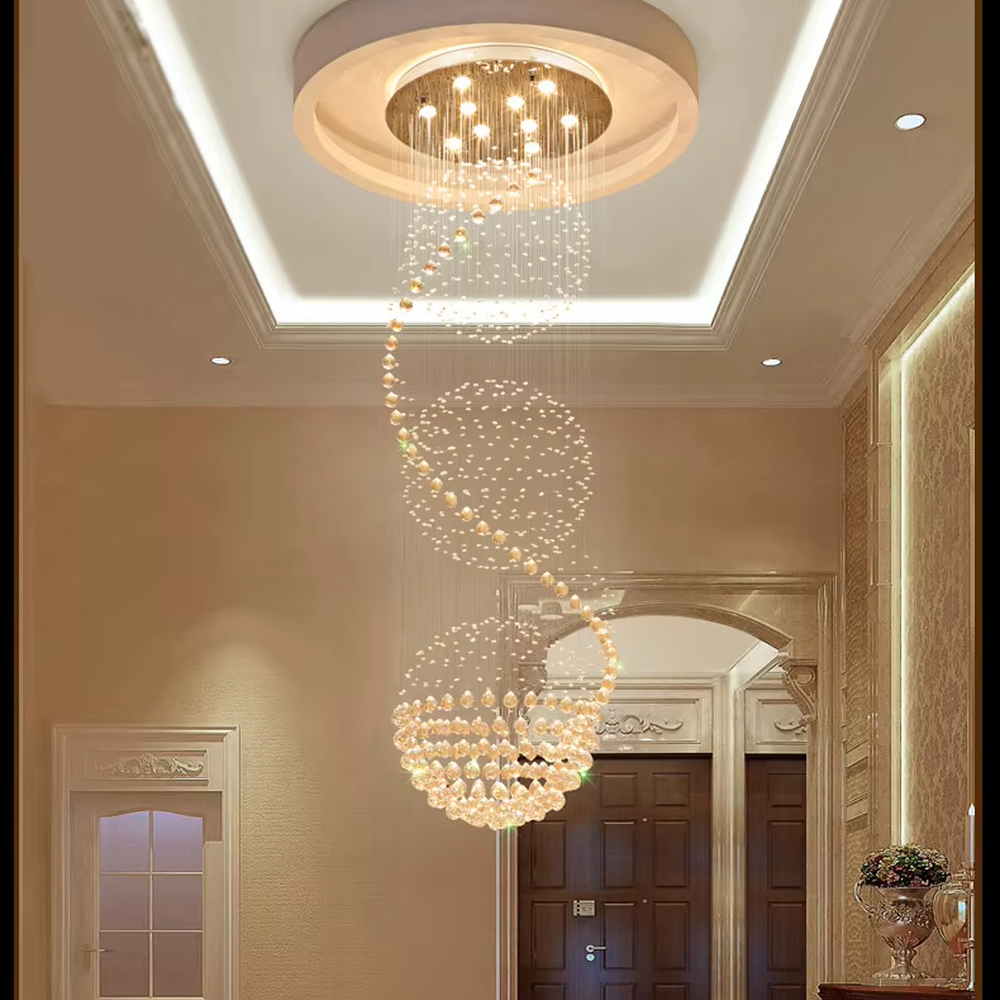 This European luxury spiral staircase crystal chandelier features a metal ceiling base, with dense crystal bead strings hanging down to form a dynamic spiral-rising shape. When lit, light refracts through the crystal to emit a brilliant and soft glow, combining a dynamic texture with an ambient atmosphere. Ideal for villa high-ceiling living rooms, hotel lobbies, duplex hollow spaces, and other areas, it adds an elegant and exquisite touch to European luxury or modern light luxury environments.