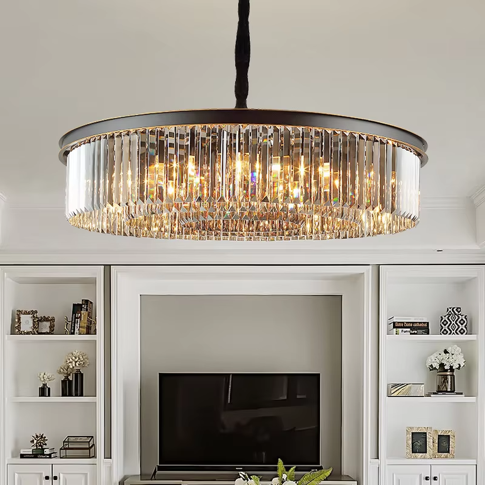 This modern light luxury circular crystal chandelier features a black metal frame, with dense transparent long crystals hanging down to form a full circular shape, suspended by a braided cord. When lit, light refracts through the crystal to emit a brilliant and soft glow, combining a bold texture with an ambient atmosphere. Ideal for living rooms, dining rooms, light luxury apartments, and other spaces, it adds an exquisite and sophisticated touch to modern minimalist or light luxury home environments.