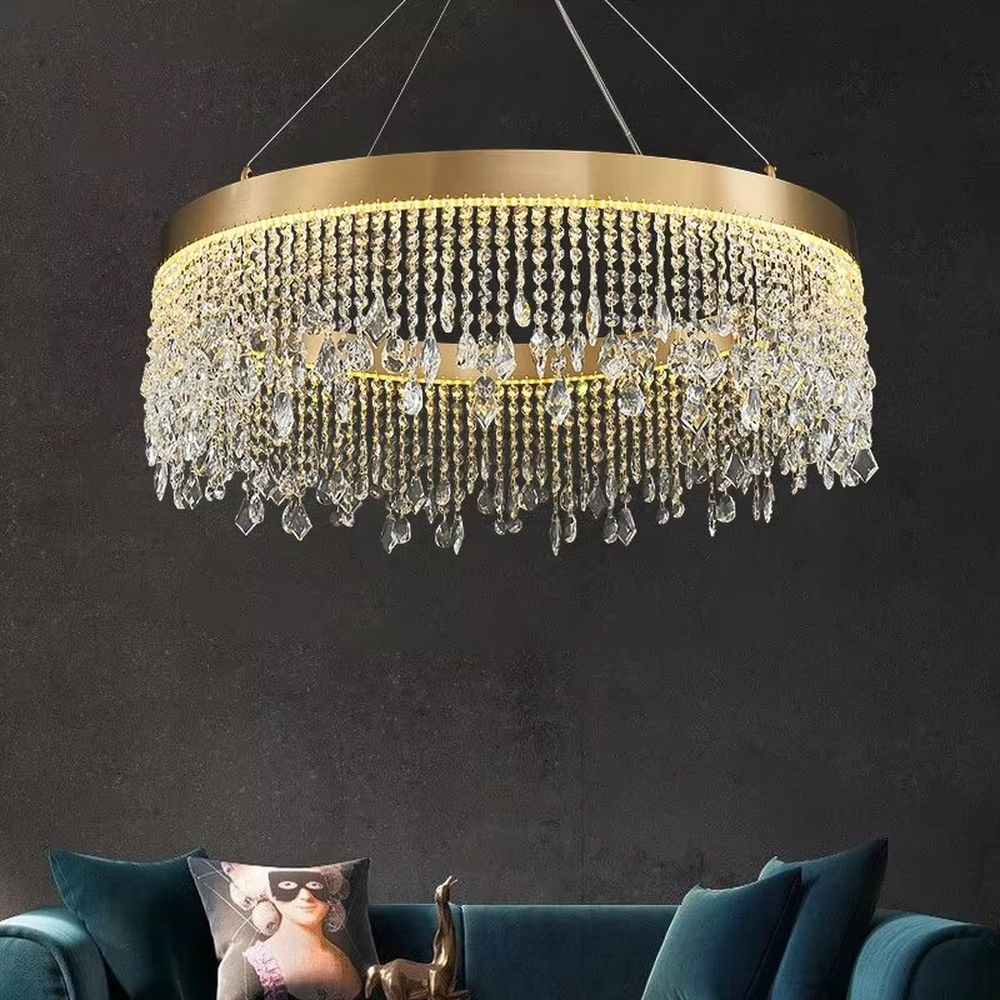 This modern light luxury circular tassel crystal chandelier features a champagne gold metal top frame, with dense crystal bead strings hanging down to form a tassel layered shape. When lit, light refracts through the crystals to emit a brilliant and soft glow, combining a luxurious texture with an ambient atmosphere. Ideal for living rooms, dining rooms, light luxury apartments, and other spaces, it adds an exquisite and sophisticated touch to modern minimalist or light luxury home environments.