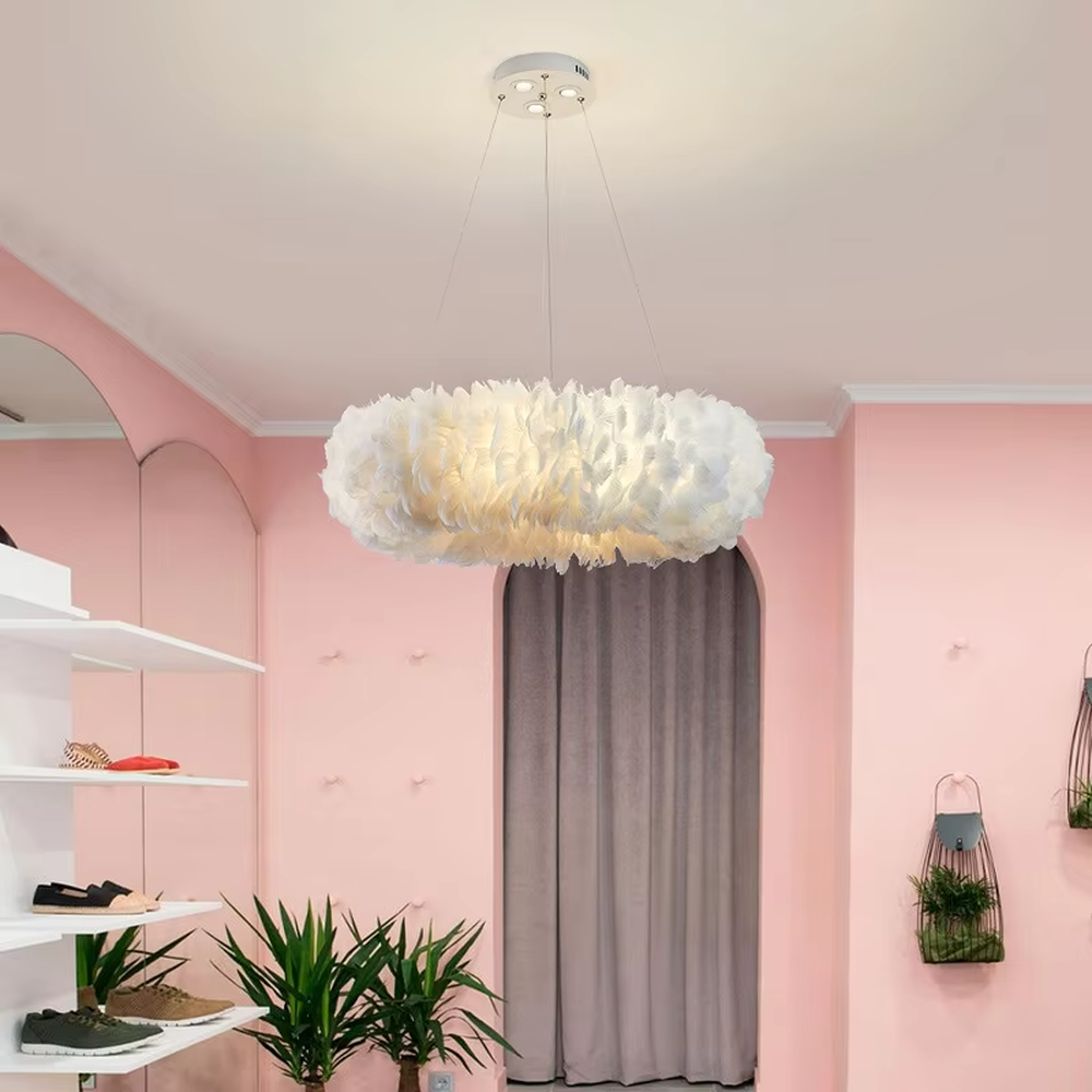 Nordic-style cloud feather chandelier, featuring a fluffy cloud-shaped lampshade made of natural white feathers. It emits soft and gentle light, combining a romantic ambiance and a soothing feel, making it a decorative lighting fixture that enhances the warmth of the space.