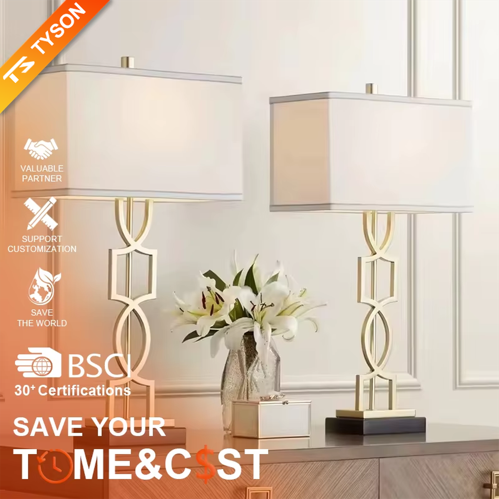 This is a luxury-style table lamp with a golden geometric hollow bracket and a white fabric square lampshade. It features a simple and elegant design with excellent texture. It is used for local desktop lighting and decoration, creating a luxurious and warm ambiance. It is suitable for luxury-style home bedroom bedside tables, high-end hotel guest rooms, modern office spaces and other places.