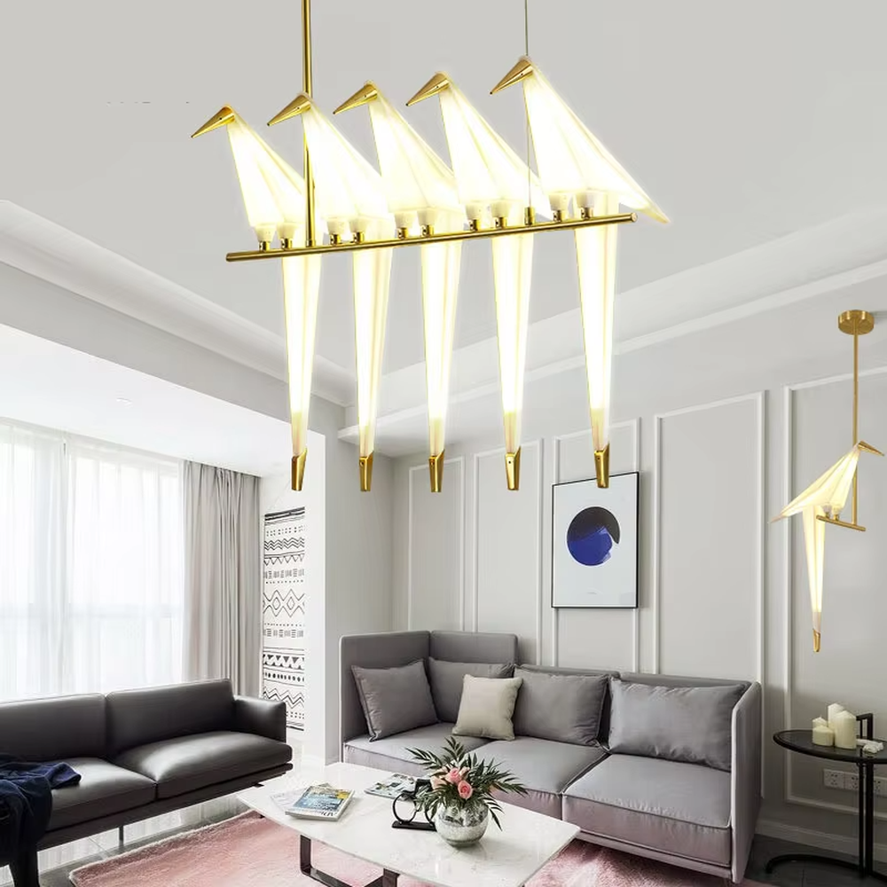 Modern art origami crane chandelier, featuring a gold metal frame paired with white origami crane-shaped lampshades made using paper folding techniques. Its elegant and dynamic lines combine artistry and ambiance, making it a decorative lighting fixture that elevates the space's style.