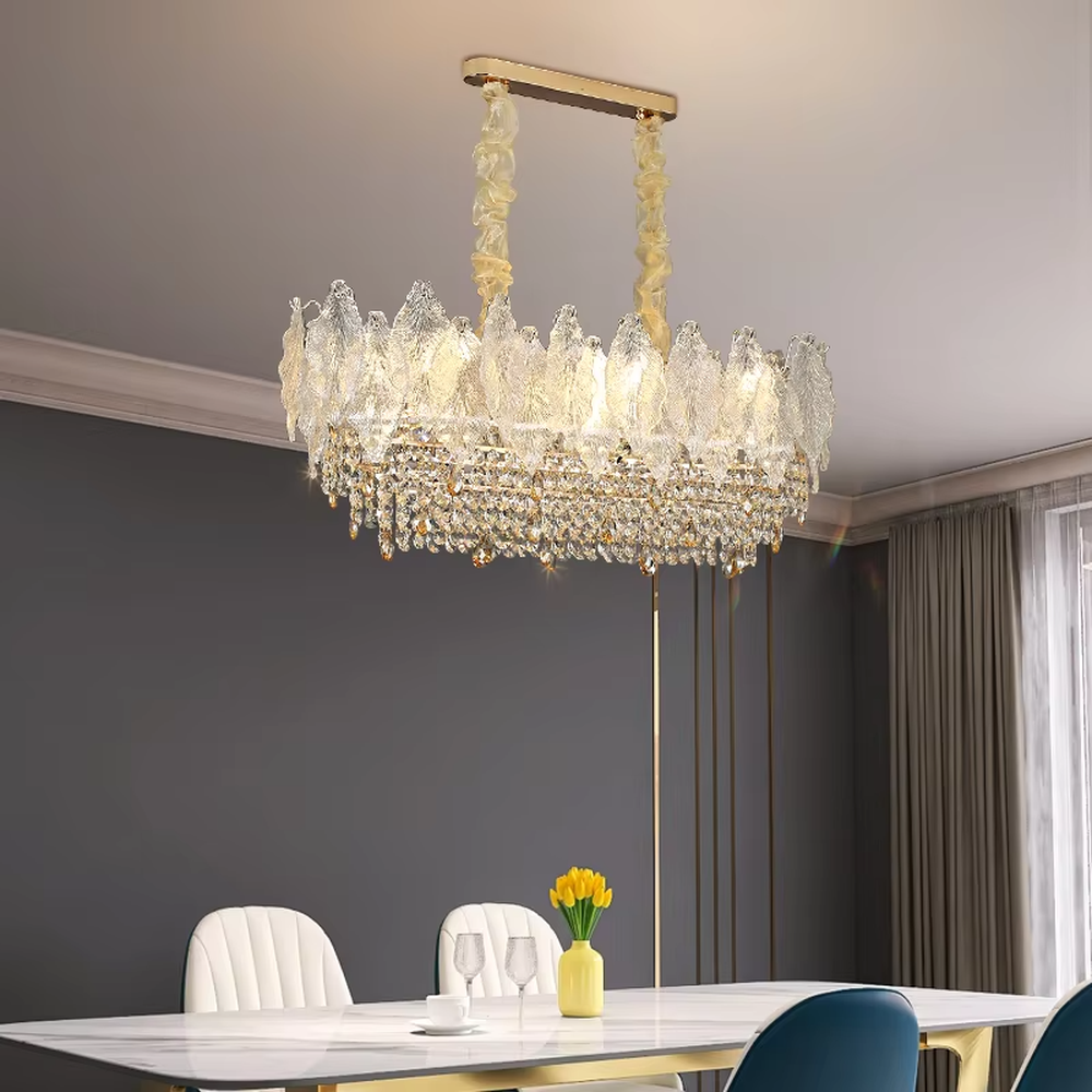 This modern light luxury two-layer chandelier features an upper layer of transparent leaf-textured glass lampshades and a lower layer of dense crystal tassels, forming a full flower crown shape. When lit, light refracts through the crystal and glass to emit a brilliant and soft glow, combining an ethereal texture with an ambient atmosphere. Ideal for living rooms, dining rooms, light luxury apartments, and other spaces, it adds a dreamy and exquisite touch to modern minimalist or French light luxury home environments.
