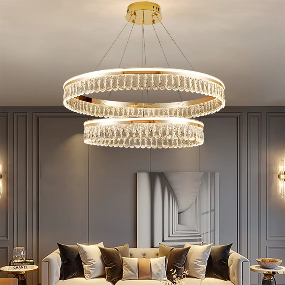 Modern light luxury double-layer ring crystal chandelier, featuring a rose gold metal frame paired with dense crystal strips to create a double-layer suspended shape. Light refracts through the crystals to produce a brilliant and soft glow, combining sophistication and ambiance, making it a high-end decorative lighting fixture that elevates the space's style.