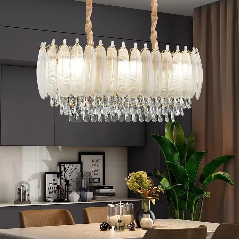 This light luxury retro two-layer chandelier features a dome shape enclosed by vertical-textured frosted glass on the upper layer, paired with hanging crystal tassels on the lower layer, all set in a gold metal frame. When lit, light refracts through the glass and crystal to emit a soft and brilliant glow, combining elegant texture with an ambient atmosphere. Ideal for dining rooms, bedrooms, light luxury living rooms, and other spaces, it adds an elegant and exquisite touch to European retro or modern light luxury home environments.
