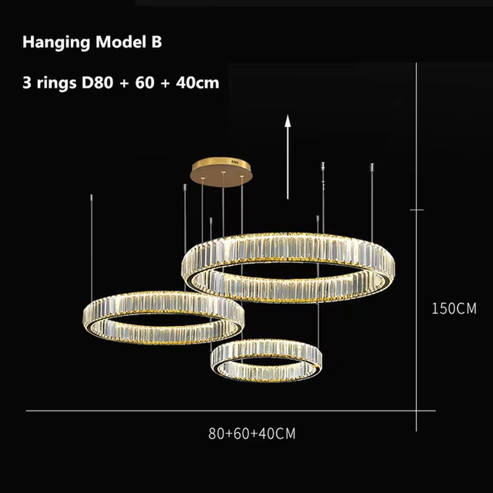 This modern light luxury multi-ring crystal chandelier consists of multiple crystal rings of varying sizes suspended in a staggered layout, each inlaid with transparent long crystals and adjustable via gold suspension wires. When lit, light refracts through the crystal to emit a brilliant and soft glow, combining layered design with an ambient atmosphere. Ideal for high-ceiling living rooms, villa foyers, hotel lobbies, or duplex spaces, it adds an exquisite and sophisticated touch to modern light luxury or minimalist environments.