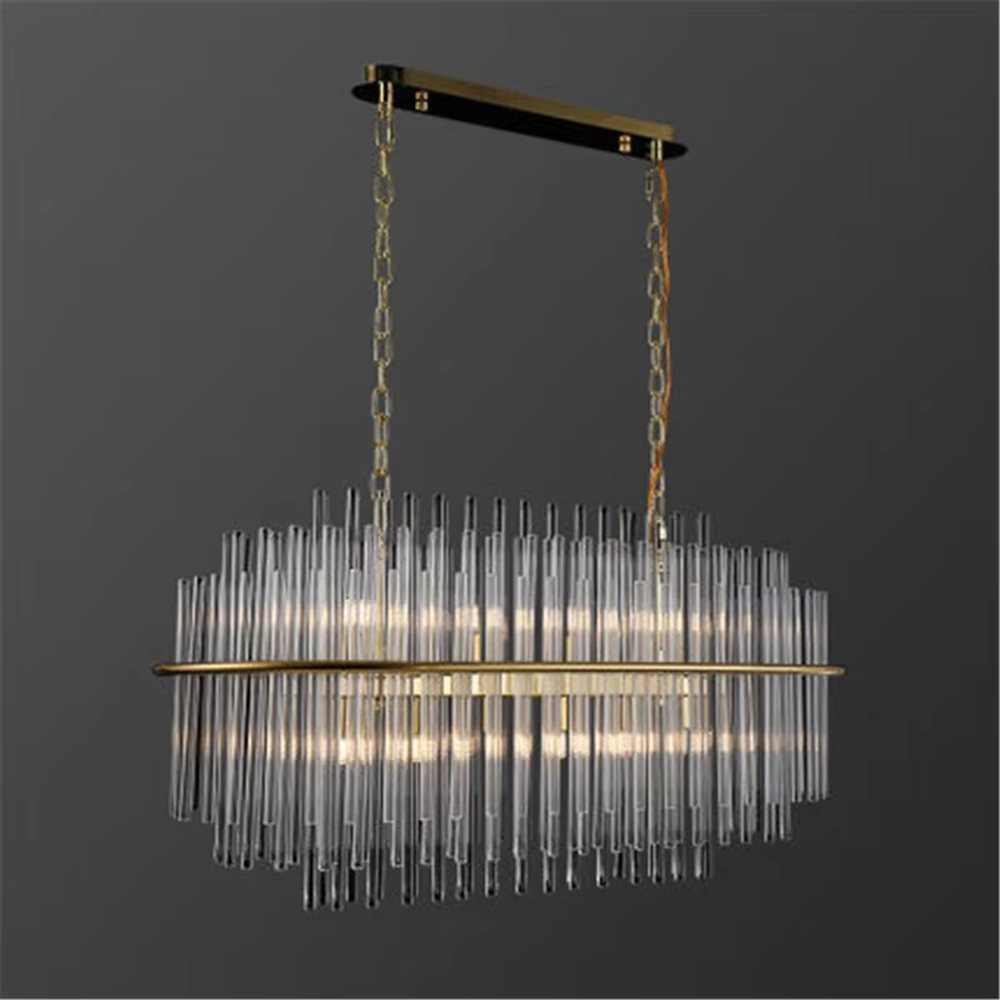 This modern light luxury square chandelier features a gold metal frame, with dense transparent glass strips hanging down to form a staggered three-dimensional shape. When lit, light refracts through the glass to emit a soft and even glow, combining a minimalist texture with an ambient atmosphere. Ideal for living rooms, dining rooms, light luxury apartments, and other spaces, it adds an exquisite and sophisticated touch to modern minimalist or Scandinavian-style home environments.