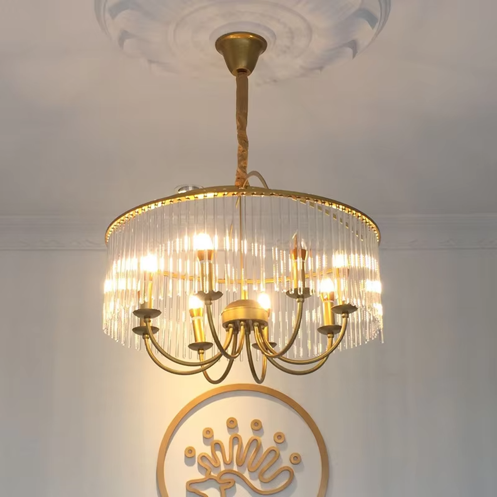 This retro light luxury crystal tassel chandelier features a brass metal frame, paired with transparent long crystal tassels that enclose a dome shape. The internal curved-arm lamp holder is equipped with candelabra light sources. When lit, light refracts through the crystal to emit a soft and brilliant glow, combining retro elegance with an ambient atmosphere. Ideal for dining rooms, bedrooms, retro-style living rooms, and other spaces, it adds an elegant and exquisite touch to American retro or European light luxury home environments.
