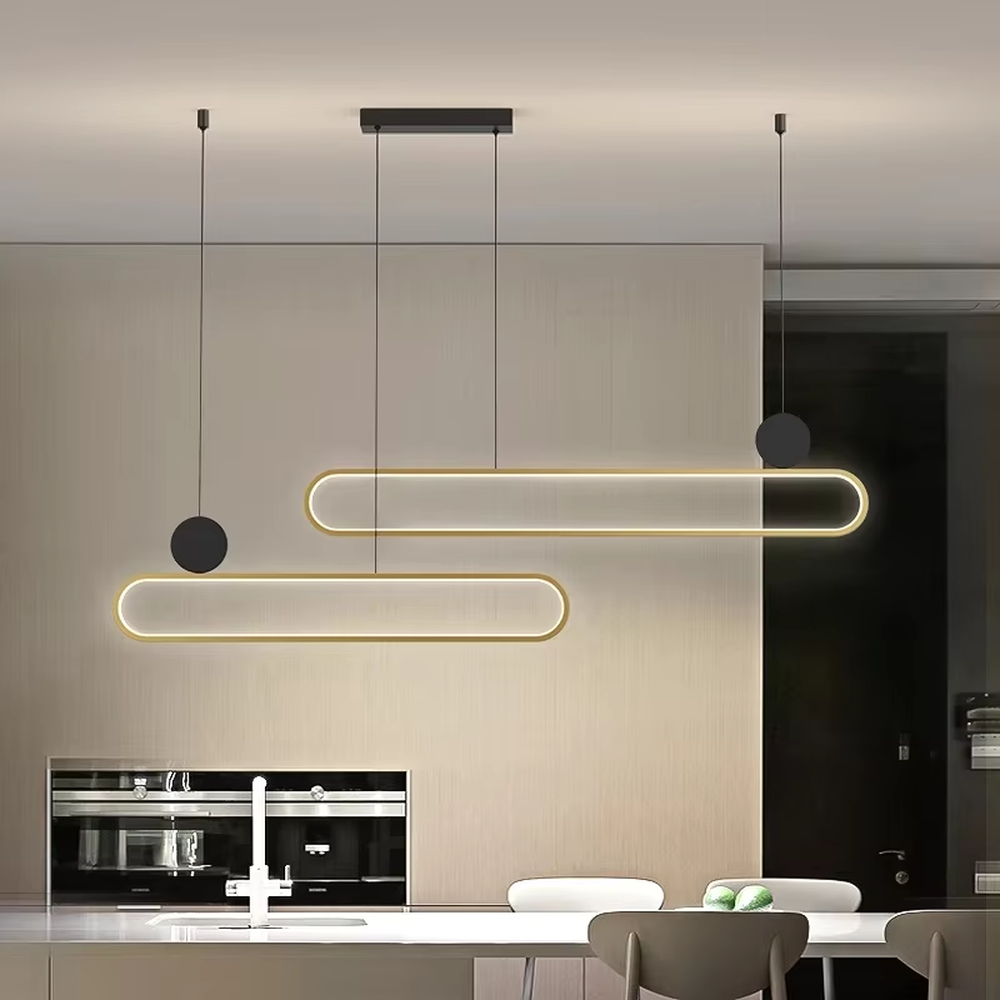 Modern light luxury black and gold linear chandelier, featuring a gold metal frame paired with a white luminous lamp body, accented with a black balancing ball on the side. Its clean and elegant lines combine style and ambiance, making it a modern home lighting fixture that enhances the space's texture.