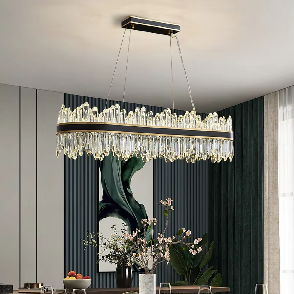 This modern light luxury two-layer circular crystal chandelier features a black-gold metal frame, with dense transparent long crystals hanging down to form a full circular shape. When lit, light refracts through the crystal to emit a brilliant and luxurious glow, combining a bold texture with an ambient atmosphere. Ideal for living rooms, dining rooms, light luxury apartments, and other spaces, it adds an exquisite and sophisticated touch to modern minimalist or light luxury home environments.