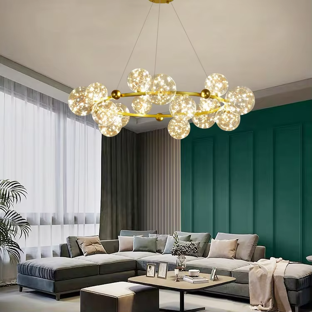This modern light luxury circular magic bean chandelier features a gold metal ring frame and multiple glass ball lampshades with a starry sky effect inside. When lit, it emits a soft and warm starry glow, combining decorative appeal with an ambient atmosphere. Ideal for living rooms, dining rooms, large apartments, and other spaces, it adds a romantic and exquisite touch to modern light luxury, minimalist, or Nordic-style home environments.