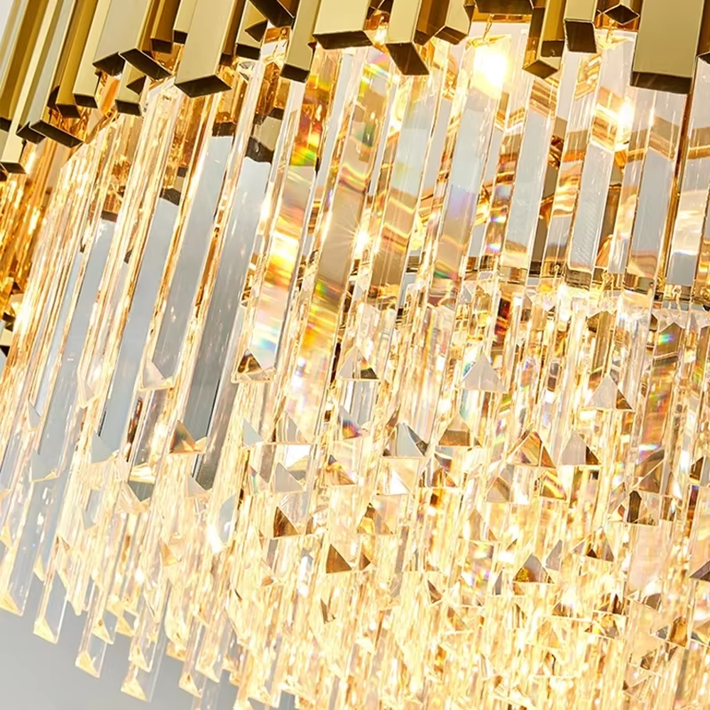 This modern light luxury two-layer linear chandelier features an upper frame enclosed by gold metal strips, with transparent crystal tassels hanging below, suspended by gold chains. When lit, light refracts through the crystal to emit a brilliant and luxurious glow, combining a luxurious texture with an ambient atmosphere. Ideal for dining rooms, bars, light luxury apartments, and other spaces, it adds an exquisite and sophisticated touch to modern minimalist or light luxury home environments.