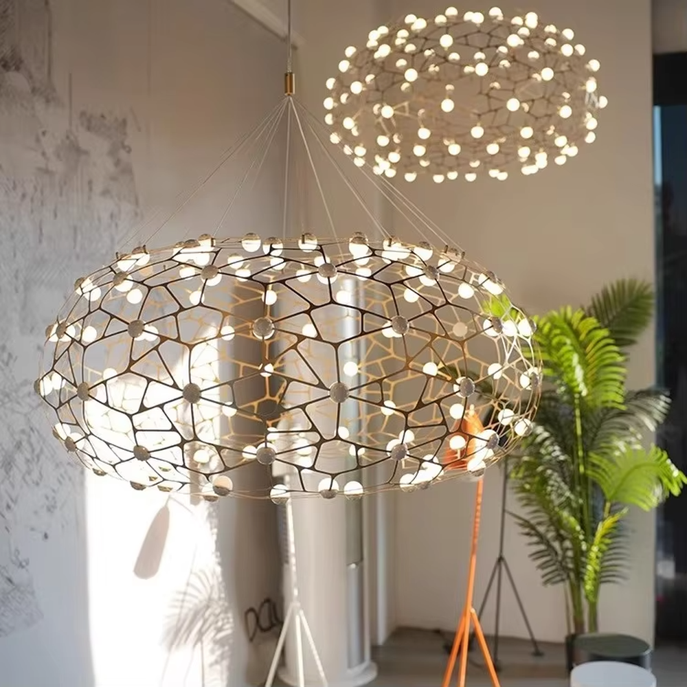 Modern light luxury honeycomb-structure oval chandelier, featuring a bionic honeycomb frame made of gold metal and covered with glowing light beads. It emits soft and brilliant light, combining a sense of technology and artistic ambiance, making it a high-end decorative lighting fixture that elevates the space's style.
