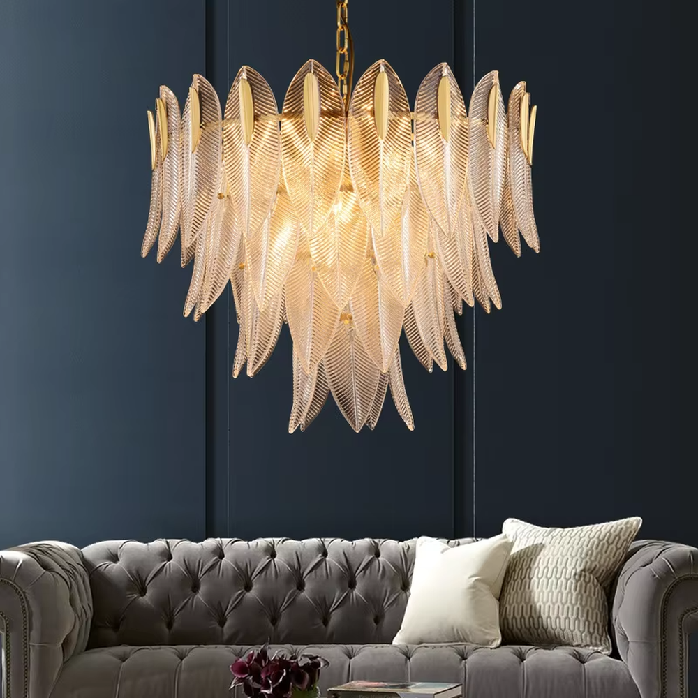 This modern light luxury feather glass chandelier features a gold metal frame, with layered textured feather-shaped glass slices forming a fan shape. When lit, light refracts through the glass to emit a soft and brilliant glow, combining an ethereal texture with an ambient atmosphere. Ideal for living rooms, dining rooms, light luxury apartments, and other spaces, it adds a dreamy and exquisite touch to modern minimalist or French light luxury home environments.