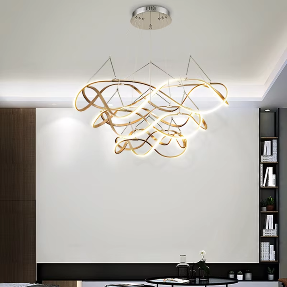 Modern art ribbon chandelier, featuring interwoven and flowing gold metal strips with built-in soft LED lighting. Its dynamic and layered lines combine artistry and ambiance, making it a high-end decorative lighting fixture that elevates the space's style.