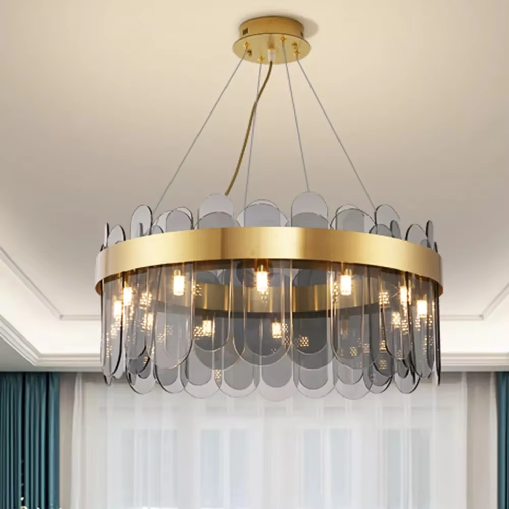 Modern light luxury smoky gray glass chandelier, featuring a ring frame in gold metal paired with layered smoky gray curved glass panels. Light refracts through the glass to create a soft and translucent glow, combining sophistication and ambiance, making it a decorative lighting fixture that elevates the space's style.
