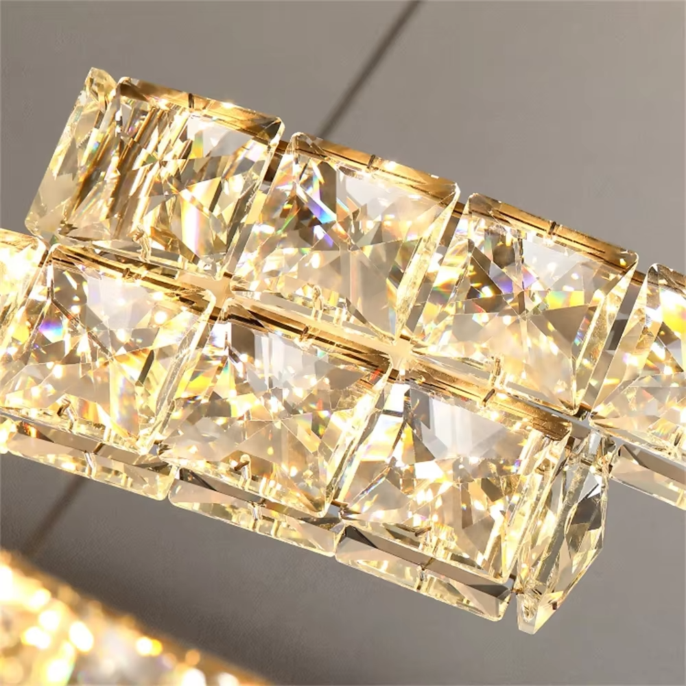 This modern light luxury double-ring interwoven crystal chandelier features a silver metal base, inlaid with transparent crystals to create a dynamic double-ring interwoven shape. When lit, light refracts through the crystal to emit a brilliant and dynamic glow, combining a futuristic feel with an ambient atmosphere. Ideal for living rooms, dining rooms, light luxury apartments, and other spaces, it adds an exquisite and sophisticated touch to modern minimalist or light luxury home environments.
