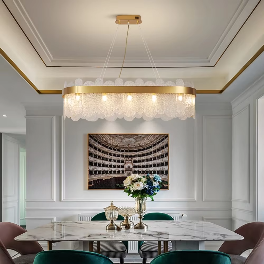 Modern light luxury smoky gray glass chandelier, featuring a ring frame in gold metal paired with layered smoky gray curved glass panels. Light refracts through the glass to create a soft and translucent glow, combining sophistication and ambiance, making it a decorative lighting fixture that elevates the space's style.
