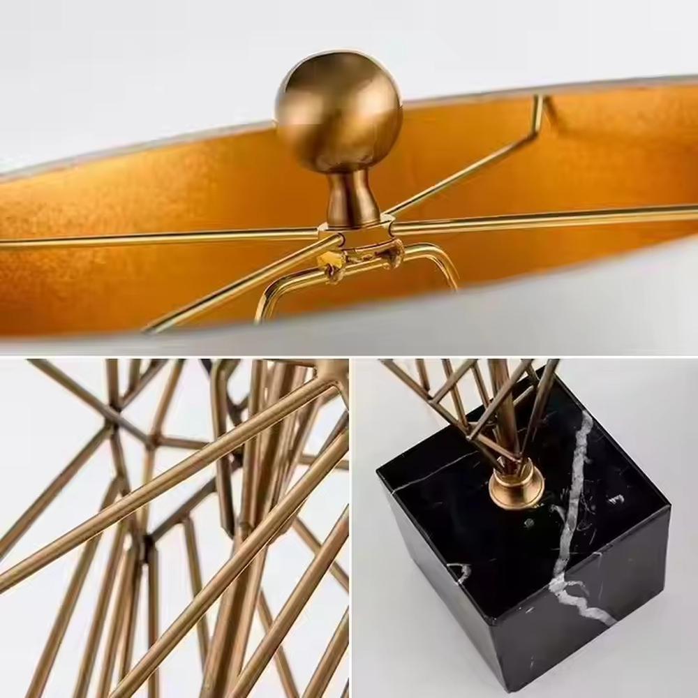 This is a luxury geometric diamond-shaped table lamp with a golden geometric hollow diamond bracket and a beige fabric lampshade. It features a simple and elegant design with excellent texture. It is used for local desktop lighting and decoration, creating a luxurious and warm ambiance. It is suitable for luxury-style home bedroom bedside tables, high-end hotel guest rooms, modern soft decoration display spaces and other places.