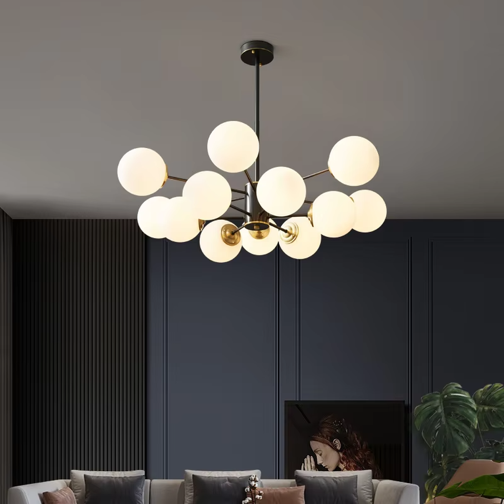 Modern light luxury magic bean chandelier, featuring a radial frame in black and gold metal paired with milk-white frosted glass ball lampshades. Its minimalist, rounded, and layered design combines warmth and style, making it a decorative lighting fixture that enhances the space's texture.