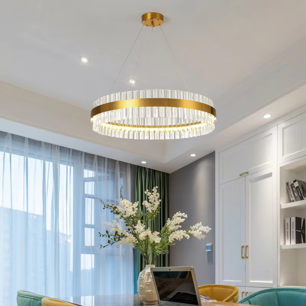 This modern light luxury circular crystal chandelier features a gold metal frame, inlaid with transparent long crystals to form a double-layered circular shape. When lit, light refracts through the crystal to emit a brilliant and soft glow, combining an exquisite texture with an ambient atmosphere. Ideal for living rooms, dining rooms, light luxury apartments, and other spaces, it adds an exquisite and sophisticated touch to modern minimalist or light luxury home environments.