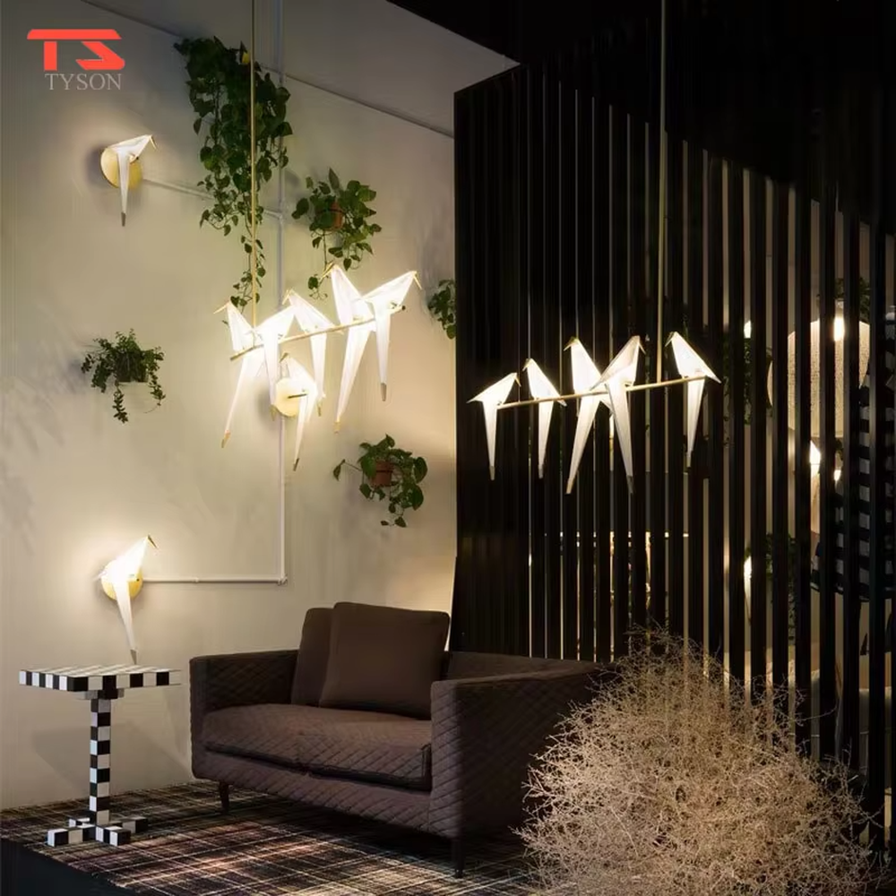 Modern art origami crane chandelier, featuring a gold metal frame paired with white origami crane-shaped lampshades made using paper folding techniques. Its elegant and dynamic lines combine artistry and ambiance, making it a decorative lighting fixture that elevates the space's style.