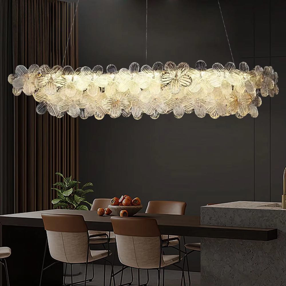 This modern light luxury linear petal chandelier features a full linear shape made of transparent petal-shaped glass slices. When lit, light refracts through the glass to emit a soft and brilliant glow, combining an ethereal texture with an ambient atmosphere. Ideal for dining rooms, bars, light luxury apartments, and other spaces, it adds a dreamy and exquisite touch to modern minimalist or French light luxury home environments.