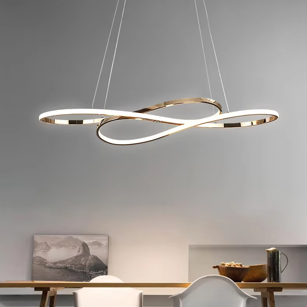 Modern light luxury infinity ring linear chandelier, featuring a fluid interwoven infinity ring structure in polished metal with built-in soft LED lighting. Its dynamic and elegant lines combine a futuristic feel and ambiance, making it a modern home lighting fixture that elevates the space's aesthetic.