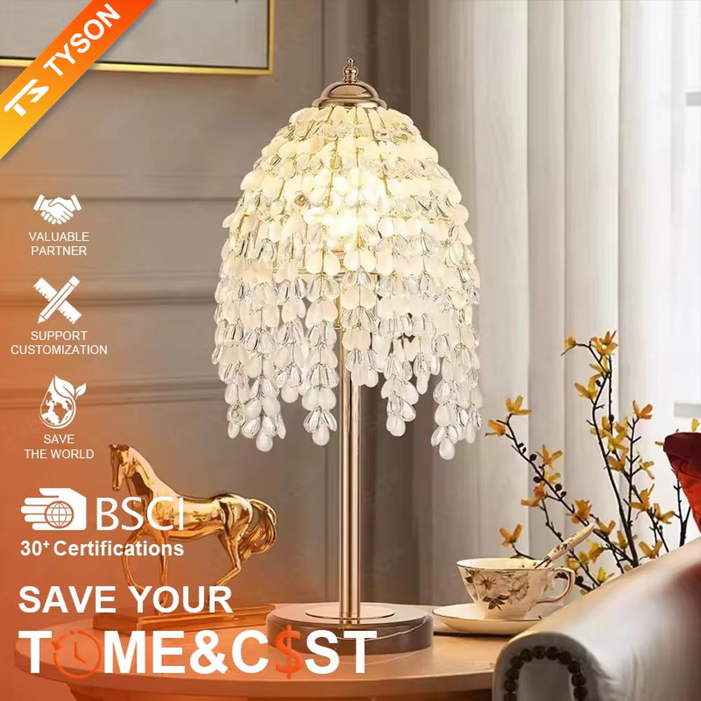 This is a luxury shell crystal table lamp with multi-layer shell-shaped crystal pendants, a golden bracket, and a black marble base, featuring a brilliant and luxurious design. It is used for local desktop lighting and decoration, creating a high-end luxurious atmosphere. It is suitable for luxury-style home bedroom bedside tables, high-end hotel guest rooms, European-style soft decoration spaces and other places.