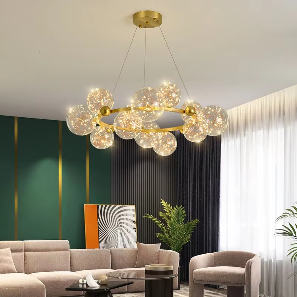 This modern light luxury circular magic bean chandelier features a gold metal ring frame and multiple glass ball lampshades with a starry sky effect inside. When lit, it emits a soft and warm starry glow, combining decorative appeal with an ambient atmosphere. Ideal for living rooms, dining rooms, large apartments, and other spaces, it adds a romantic and exquisite touch to modern light luxury, minimalist, or Nordic-style home environments.