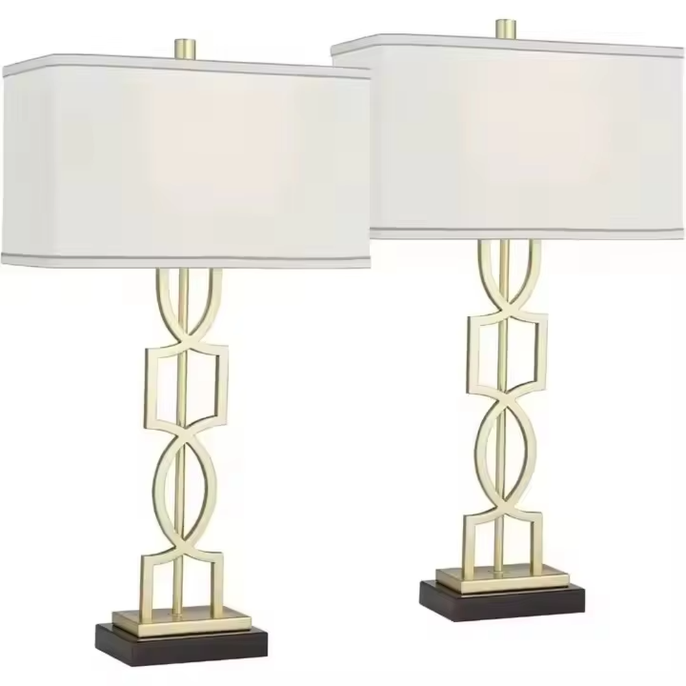 This is a luxury-style table lamp with a golden geometric hollow bracket and a white fabric square lampshade. It features a simple and elegant design with excellent texture. It is used for local desktop lighting and decoration, creating a luxurious and warm ambiance. It is suitable for luxury-style home bedroom bedside tables, high-end hotel guest rooms, modern office spaces and other places.