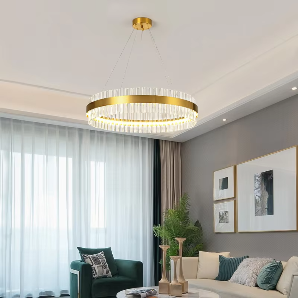 This modern light luxury circular crystal chandelier features a gold metal frame, inlaid with transparent long crystals to form a double-layered circular shape. When lit, light refracts through the crystal to emit a brilliant and soft glow, combining an exquisite texture with an ambient atmosphere. Ideal for living rooms, dining rooms, light luxury apartments, and other spaces, it adds an exquisite and sophisticated touch to modern minimalist or light luxury home environments.