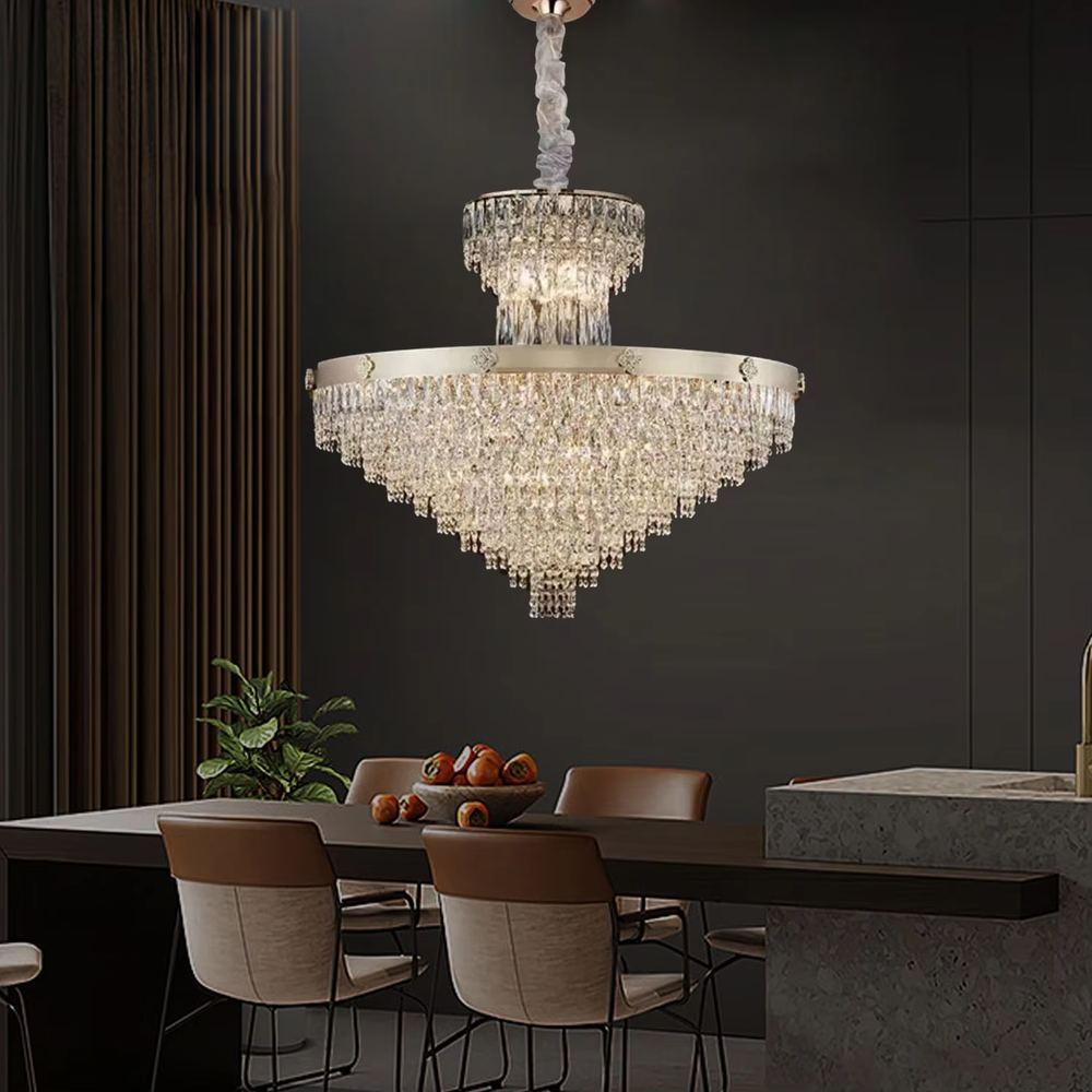 This European luxury two-layer conical crystal chandelier features a champagne gold metal frame, with dense long crystals hanging down to form a two-layer conical layered shape, suspended by a braided cord. When lit, light refracts through the crystals to emit a brilliant and luxurious glow, combining a luxurious texture with an ambient atmosphere. Ideal for villa living rooms, luxury dining rooms, high-end clubs, and other spaces, it adds an elegant and exquisite touch to European luxury or modern light luxury environments.