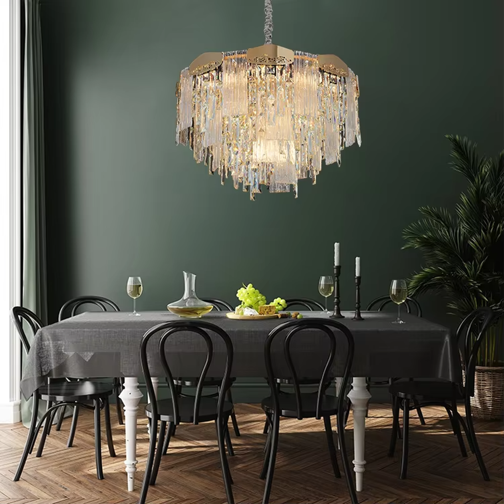 This modern light luxury multi-layer crystal tassel chandelier features a gold metal frame, with multiple layers of transparent long crystal tassels hanging down to form a full square dome shape. When lit, light refracts through the crystal to emit a brilliant and soft glow, combining luxurious texture with an ambient atmosphere. Ideal for dining rooms, living rooms, light luxury apartments, and other spaces, it adds an elegant and exquisite touch to modern minimalist or light luxury home environments.